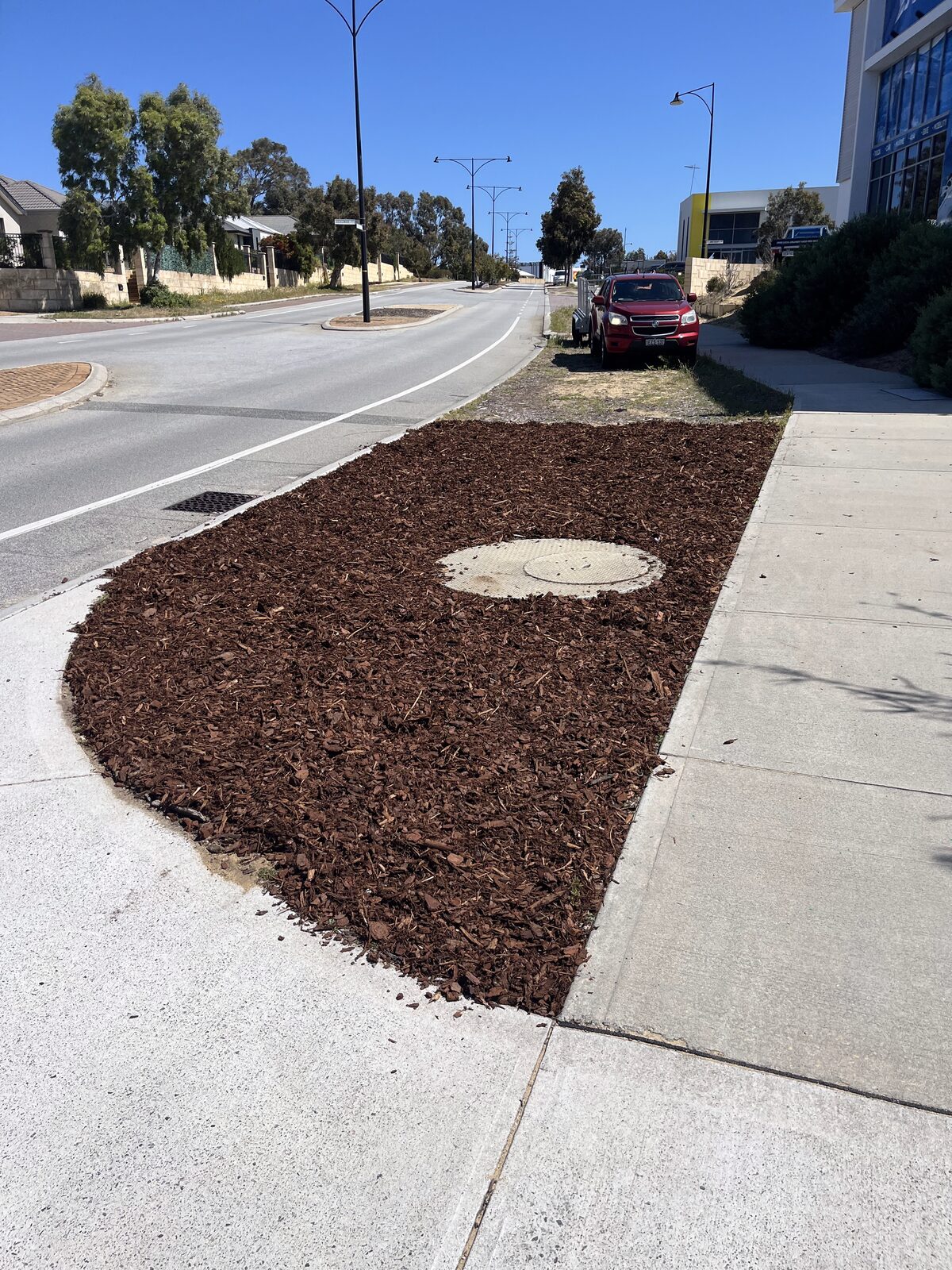 Finished streetscape mulching — commercial verge after our green waste work