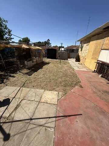 Cleaned paved area at the rear of the property