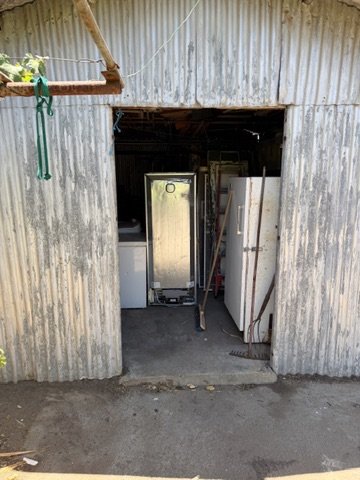 Cleared shed entrance after items were removed